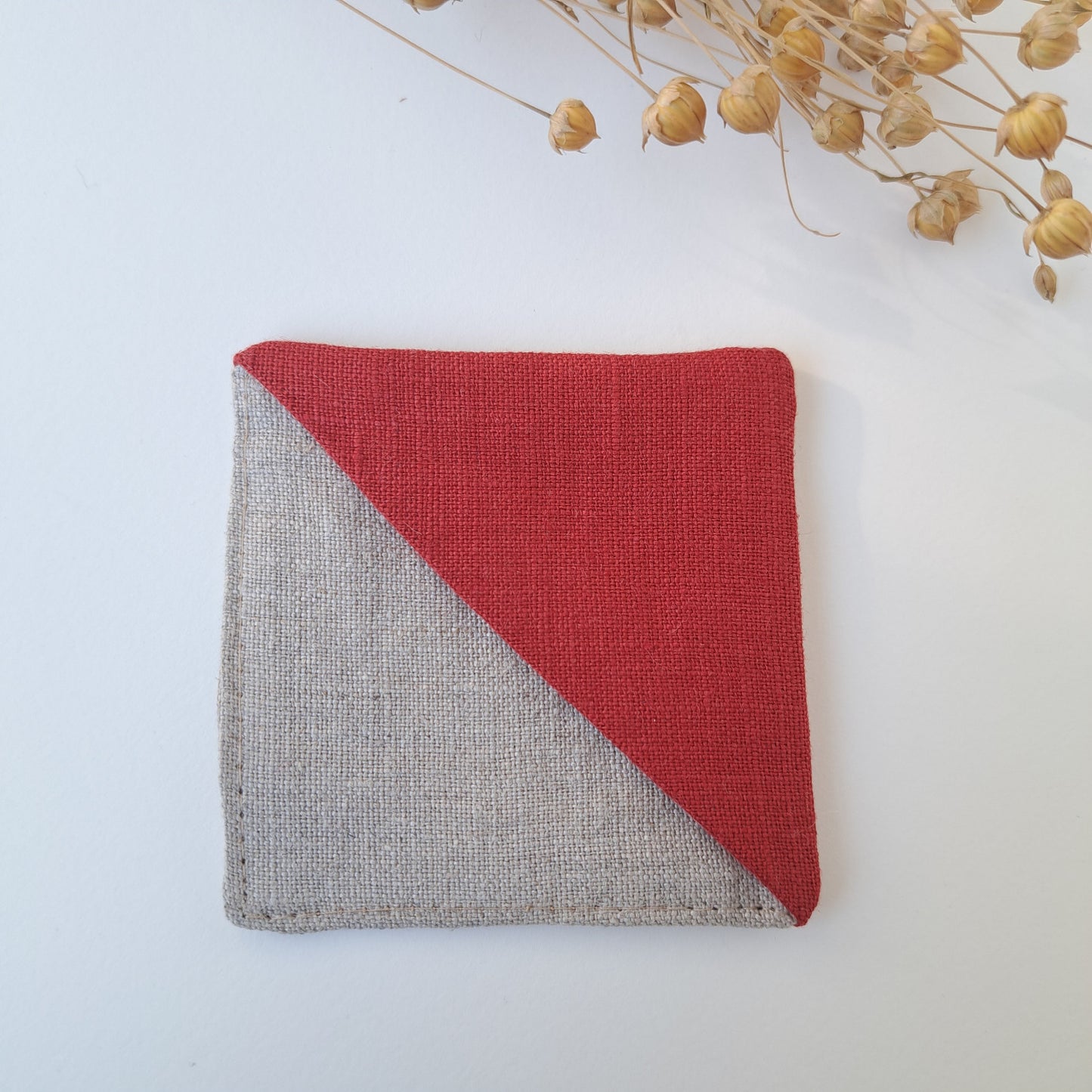 Kulmakirjanmerkki, tausta pellavanvärinen, punainen kulma.